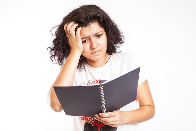 Confused. A college student is confused by her class notes